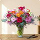 Image du Bouquet Frida aux fleurs fuchsia, orange et rose, composition florale ronde et artistique livrée par 123fleurs